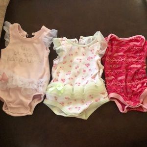 Three baby girl onesies.